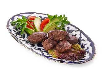 Meat on a grill with vegetables