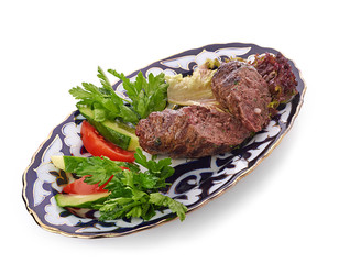 Meat on a grill with vegetables