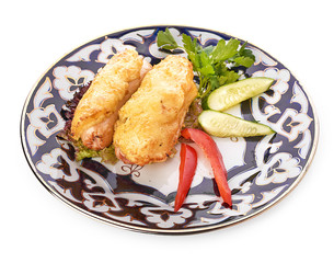 A pile of chicken nuggets on white plate with sauce