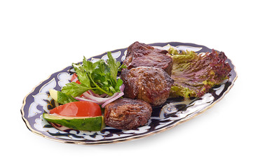 Meat on a grill with vegetables