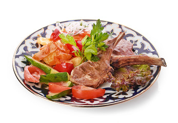 Meat on a grill with vegetables