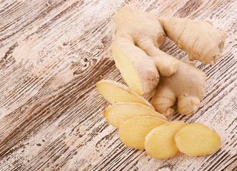 Ginger root sliced on wooden table