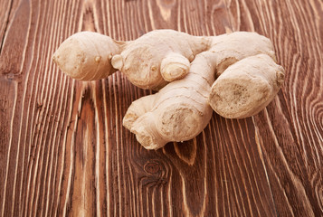 Ginger root sliced on wooden table
