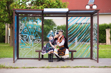 Couple in love sitting at the bus stop.