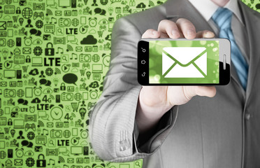 A man holding smartphone with one new message on a screen.