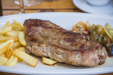 Beef steak with fries and vegetables
