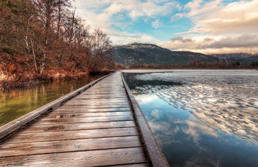Fototapeta premium Boardwalk on Lake with melting Ice
