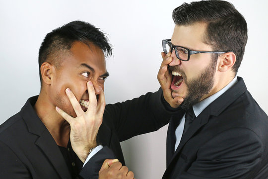 two young businessmen fighting
