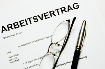 Arbeitsvertrag mit Geld und Füller