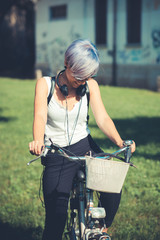 young beautiful short blue hair hipster woman with headphones an