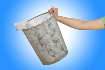 Fototapeta na wymiar Hands with garbage bin with paper