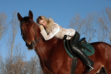 Romantic female jockey riding a horse outdoors