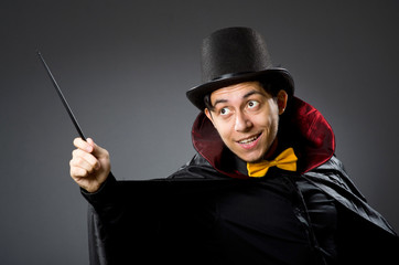 Funny magician man with wand and hat