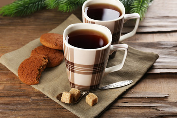 Cups of tea with cookies on table close-up