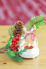 Candle and berries on pine brunch