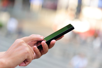 young woman hands use cellphone in city 