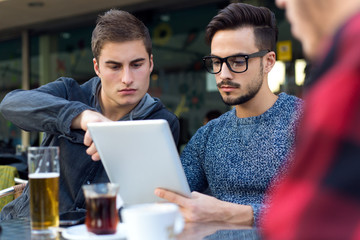 Outdoor portrait of young entrepreneurs working at coffee bar.