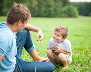 Fototapeta na wymiar Vater und Sohn unterhalten sich im park