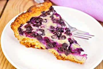 Pie blueberry in plate and napkin on board