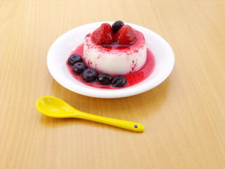 milk pudding dessert with strawberry and blue berry