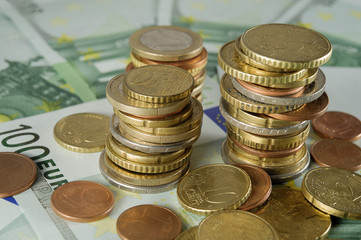 stack of Euro coins to banknotes 100 Euro