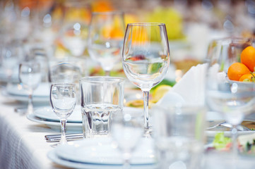 Big celebratory served table with glasses and plates
