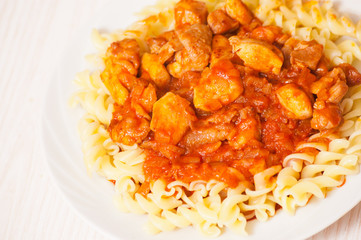 Fusilli pasta with chicken in tomato sauce