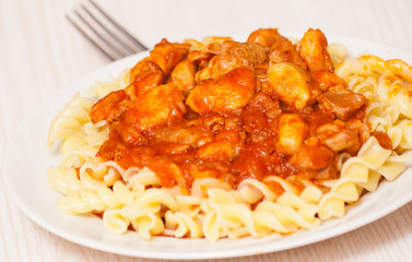 Fusilli pasta with chicken in tomato sauce