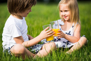 Brother and sister drink juice