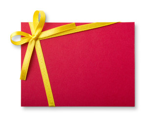 Blank red gift tag tied with a bow of gold satin ribbon