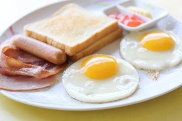 Breakfast with ham , fried egg and bread