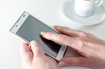 Businesswoman using a smartphone during coffee break