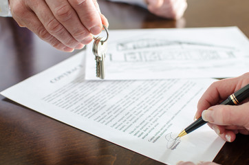Woman signing a real estate contract