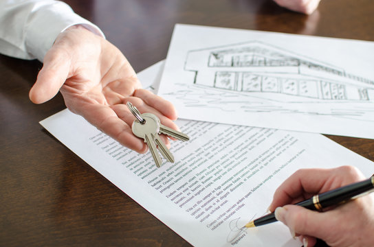 Woman signing a real estate contract