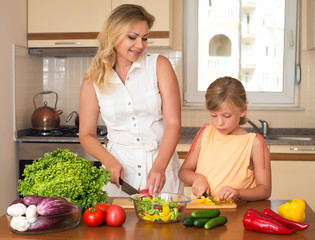Healthy domestic food concept. Mother and daughter cooking.