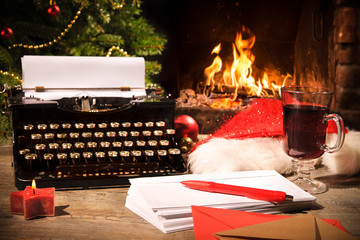 Old typewriter and Santa Claus hat on desk