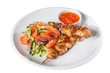  Skewers with vegetables and sauce on the white plate