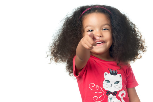 Afroamerican Small Girl Pointing To The Camera And Laughing