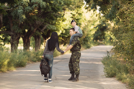 Family And Soldier In A Military Uniform Say Goodbye