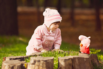 Funny little girl in autumn forest