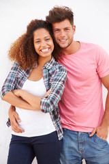 Portrait Of Couple Standing Outdoors Against White Wall