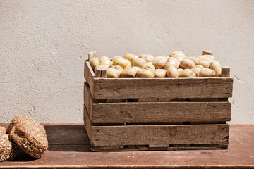 Fresh farm potatoes in a wooden box