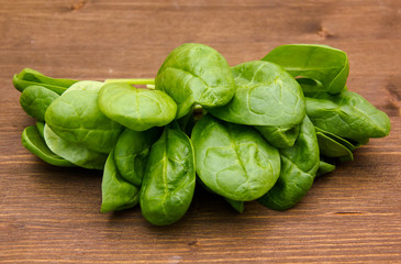 Some leaves Fresh spinach on wooden table