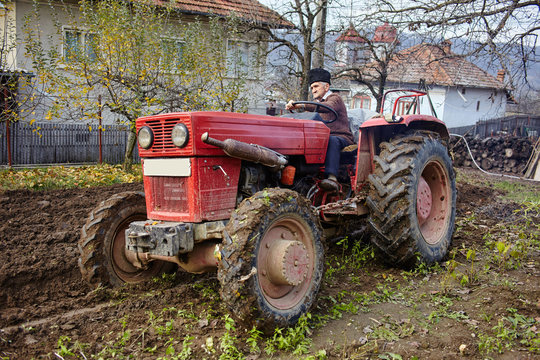 Senior farmer plowing