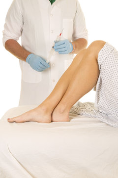 Woman patient legs doctor needle hold up