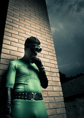 Cool superhero leaning to a brick wall