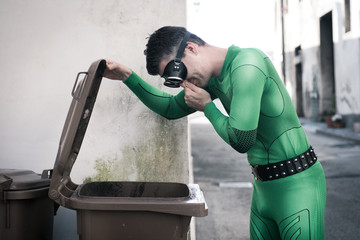 Superhero opening a trash bin