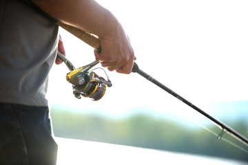 Modern clean fishing rod in hands
