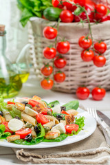 Healthy salad with vegetables, pasta and croutons