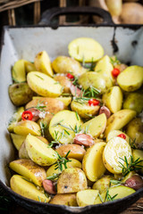 Closeup of baking potatoes with garlic and rosemary
